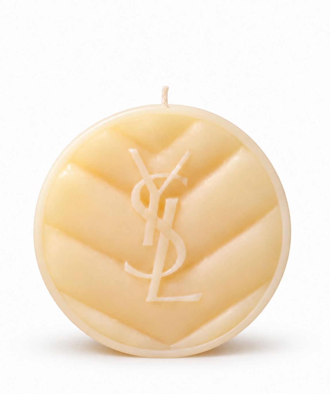 Mini cream sculpted candle with a centered wick